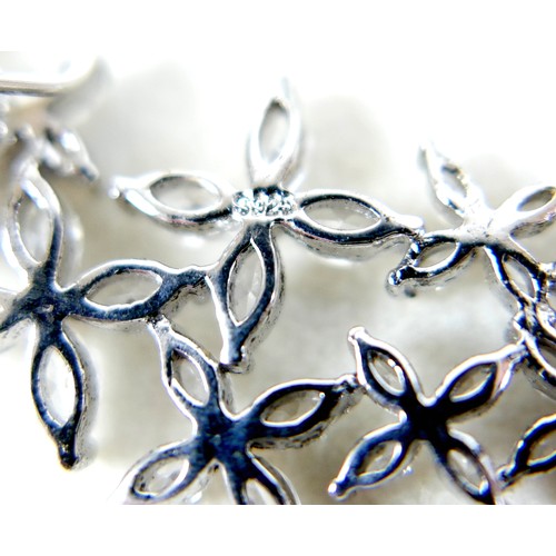 41 - A pair of silver Swarovski star burst Christmas party earrings, 54 by 22mm.