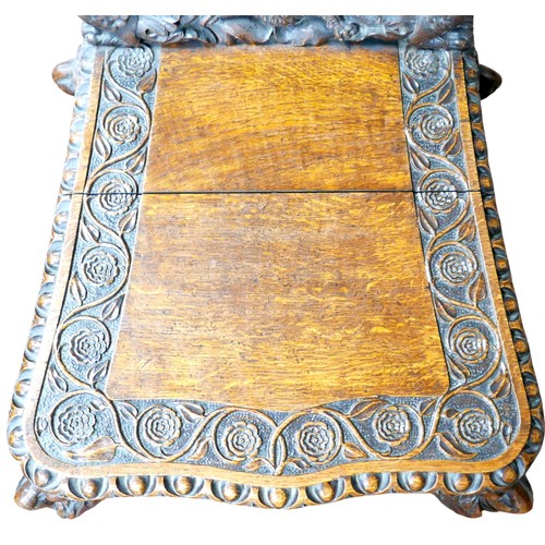 397 - The Burghley Chair: a Victorian heavily carved oak Armorial hall chair, dated 1866, profusely carved... 