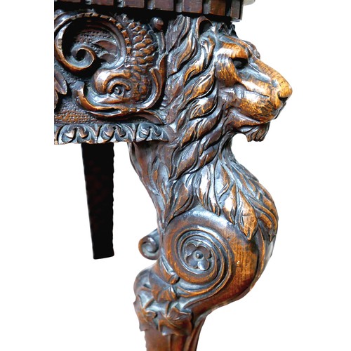 397 - The Burghley Chair: a Victorian heavily carved oak Armorial hall chair, dated 1866, profusely carved... 