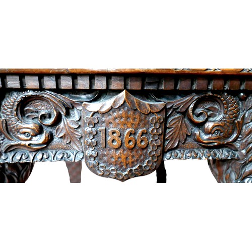 397 - The Burghley Chair: a Victorian heavily carved oak Armorial hall chair, dated 1866, profusely carved... 