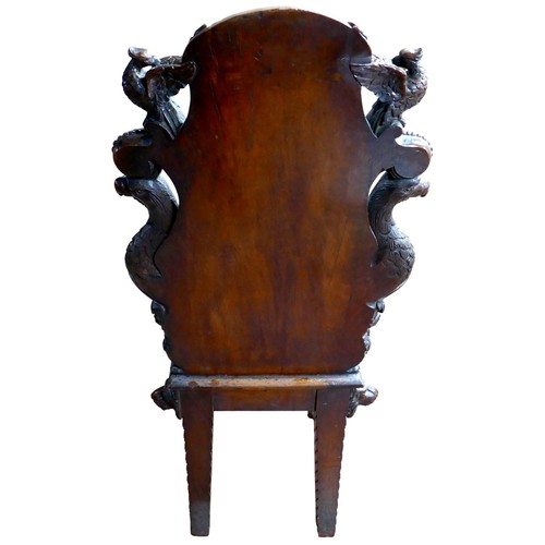 397 - The Burghley Chair: a Victorian heavily carved oak Armorial hall chair, dated 1866, profusely carved... 