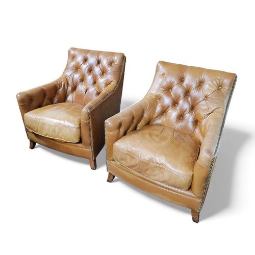 396 - A pair of Tetrad button back tan leather upholstered armchairs, both with fire labels, 74 by 82 by 8... 