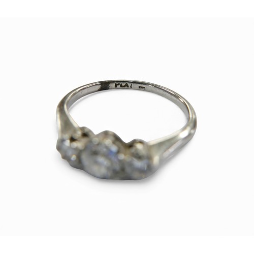 24 - A platinum and diamond three stone ring, the largest central stone approximately 4.5mm in diameter, ... 