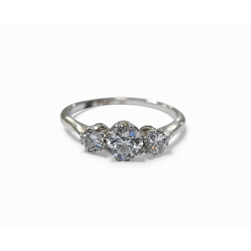 24 - A platinum and diamond three stone ring, the largest central stone approximately 4.5mm in diameter, ... 