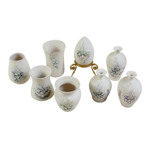 162 - A collection of eight pieces of porcelain by Mollie Hillam, to include three small vases and one pie... 
