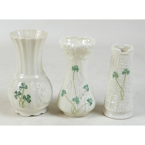 163 - A collection of seven Belleek pieces of pottery to include three shamrock vases and a shell designed... 