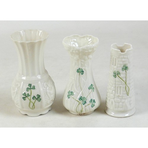 163 - A collection of seven Belleek pieces of pottery to include three shamrock vases and a shell designed... 