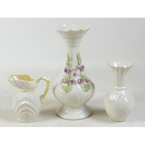 163 - A collection of seven Belleek pieces of pottery to include three shamrock vases and a shell designed... 
