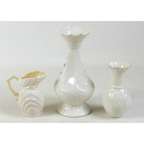 163 - A collection of seven Belleek pieces of pottery to include three shamrock vases and a shell designed... 