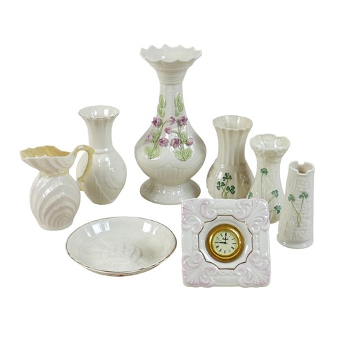 163 - A collection of seven Belleek pieces of pottery to include three shamrock vases and a shell designed... 