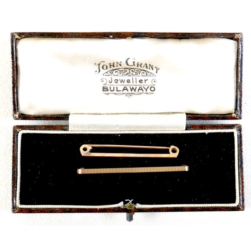27 - Two 9ct gold tie-pins, 4.2g overall, together with a vintage 'John Grant Jeweller Bulawayo' box. (1 ... 