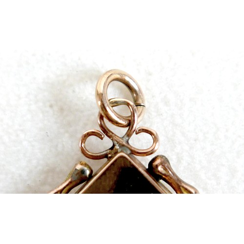 14 - A ruby-set gilt metal locket, 3cm square, marked '9ct gold back & front' and stamped 'silver setting... 