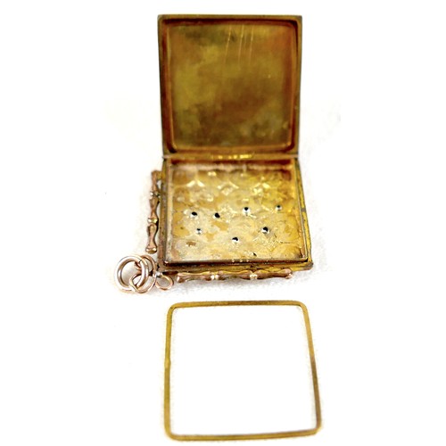 14 - A ruby-set gilt metal locket, 3cm square, marked '9ct gold back & front' and stamped 'silver setting... 