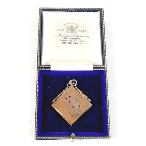 14 - A ruby-set gilt metal locket, 3cm square, marked '9ct gold back & front' and stamped 'silver setting... 