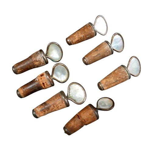 138 - A collection of seven mother of pearl decanter corks. (6)