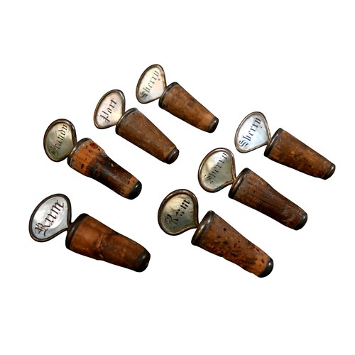 138 - A collection of seven mother of pearl decanter corks. (6)
