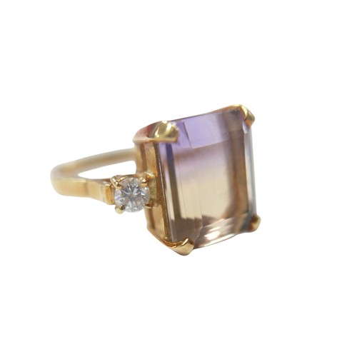 76 - An 18ct yellow gold bi-colour tourmaline and diamond ring the central stone approximately 6ct flanke... 