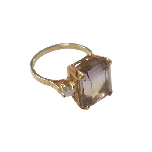 76 - An 18ct yellow gold bi-colour tourmaline and diamond ring the central stone approximately 6ct flanke... 