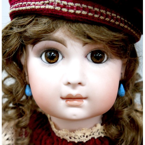 21 - Two 20th century bisque headed dolls, including a large doll with glass eyes and closed mouth 28 1/2... 