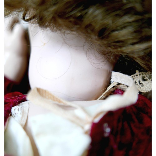 21 - Two 20th century bisque headed dolls, including a large doll with glass eyes and closed mouth 28 1/2... 