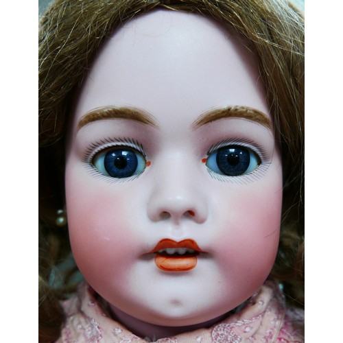 26 - A large Simon & Halbig doll, with glass eyes, painted features, open mouth with an upper row of porc... 