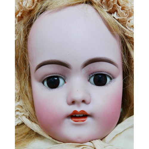 31 - An early 20th century large Simon & Halbig bisque headed doll, with glass eyes, painted features, an... 