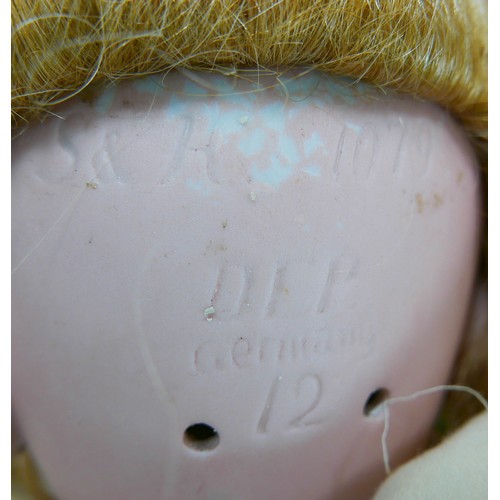 31 - An early 20th century large Simon & Halbig bisque headed doll, with glass eyes, painted features, an... 