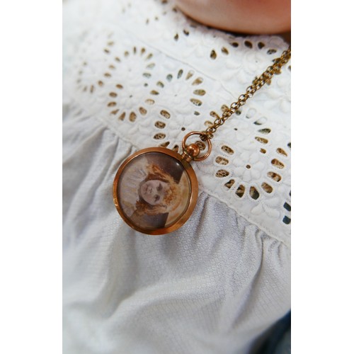 35 - A late 19th century/early 20th century continental bisque headed doll, with sleepy eyes, hand painte... 