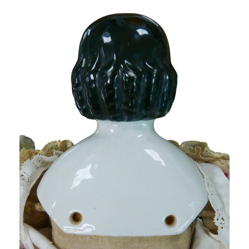 48 - A 19th century German porcelain shoulder-head pink tinted doll, with Covered wagon style painted hai... 