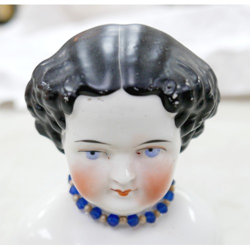 51 - Four 19th century bisque dolls' shoulder-heads, all with hand painted features and middle partings t... 