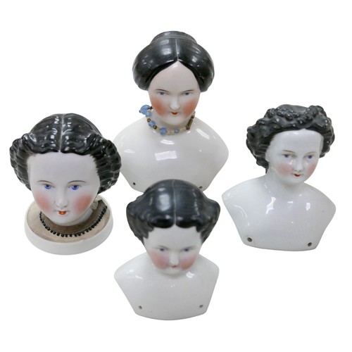 52 - Four 19th century bisque doll heads, comprising three 19th century bisque shoulder-head dolls, all w... 