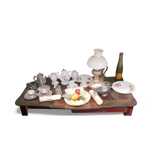 69 - A group of doll's house furniture and accessories, including a dining table with food, three figures... 
