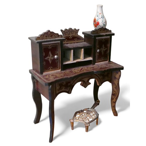 69 - A group of doll's house furniture and accessories, including a dining table with food, three figures... 