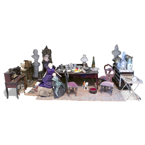 69 - A group of doll's house furniture and accessories, including a dining table with food, three figures... 