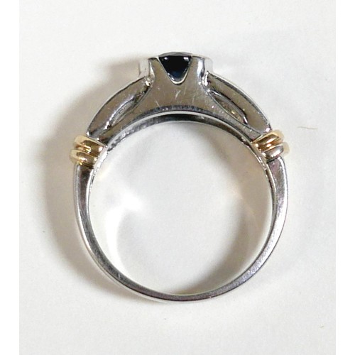 156 - An 18ct gold sapphire and diamond ring, the central round cut sapphire approximately 5mm diameter, w... 