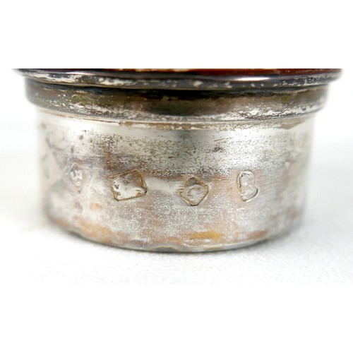 170 - A pair of Elizabeth II silver hurricane lamps with a rose column on a weighted circular footed base ... 