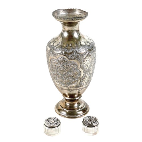 169 - A white metal eastern vase and two small silver top glass pots, the vase of baluster form decorated ... 