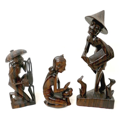 173 - A collection of four wooden carved figures, to include a woman kneeling, signed 'Rema Bali' to base,... 