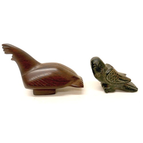 173 - A collection of four wooden carved figures, to include a woman kneeling, signed 'Rema Bali' to base,... 