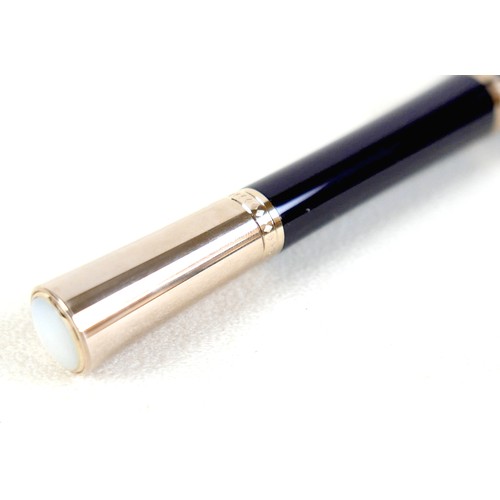 220 - A Montblanc Princess Grace of Monaco roller ball pen, in royal purple and gold trim with pink sapphi... 