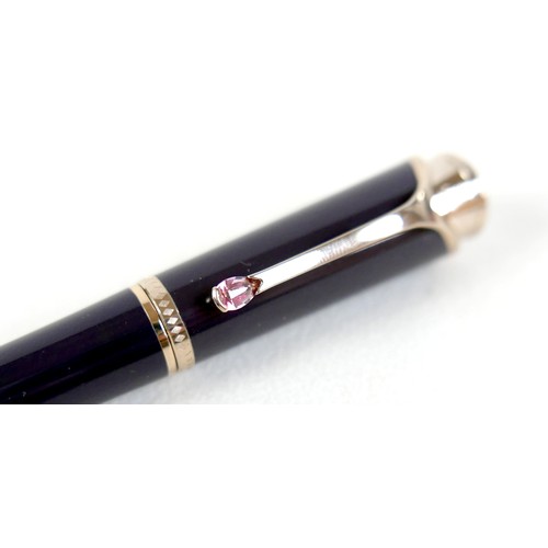 220 - A Montblanc Princess Grace of Monaco roller ball pen, in royal purple and gold trim with pink sapphi... 