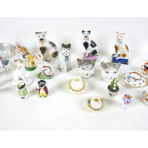 53 - A collection of miniature ceramics, including nine Staffordshire & Continental figures, modelled as ... 