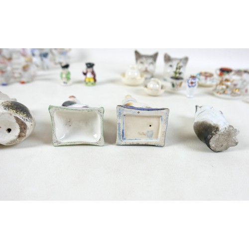 53 - A collection of miniature ceramics, including nine Staffordshire & Continental figures, modelled as ... 