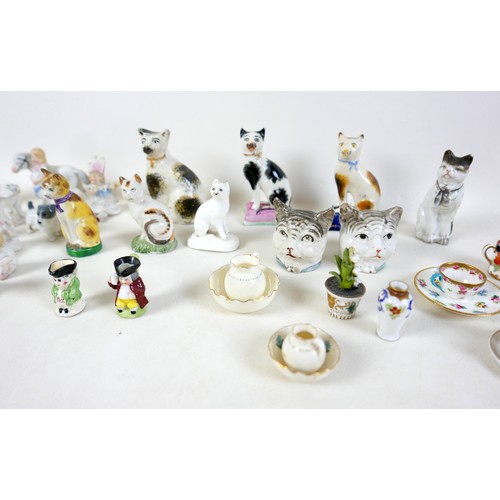 53 - A collection of miniature ceramics, including nine Staffordshire & Continental figures, modelled as ... 