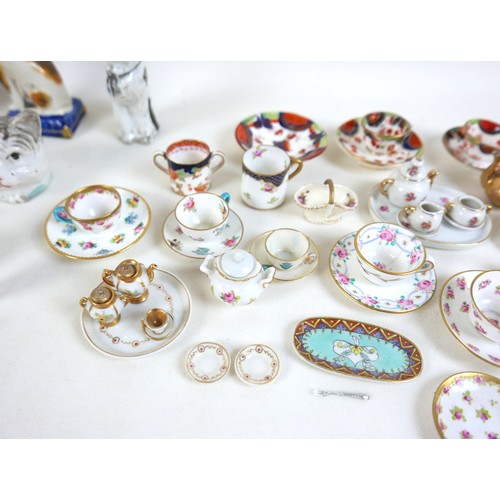 53 - A collection of miniature ceramics, including nine Staffordshire & Continental figures, modelled as ... 