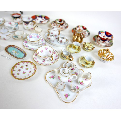 53 - A collection of miniature ceramics, including nine Staffordshire & Continental figures, modelled as ... 