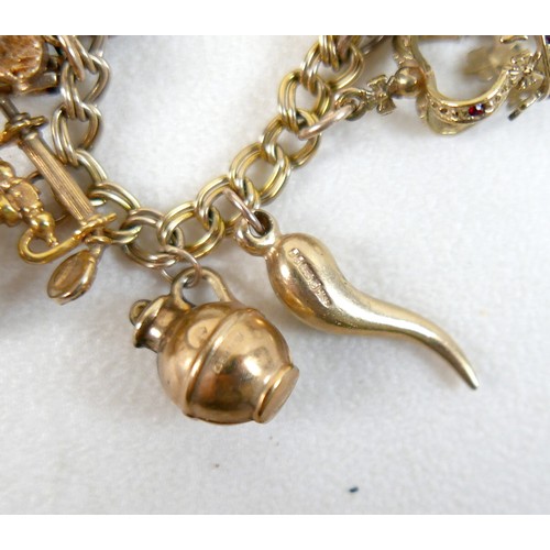 174 - A 9ct yellow gold charm bracelet with eight charms, 25.7g.
