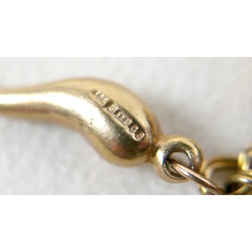 174 - A 9ct yellow gold charm bracelet with eight charms, 25.7g.