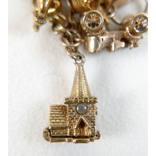 174 - A 9ct yellow gold charm bracelet with eight charms, 25.7g.