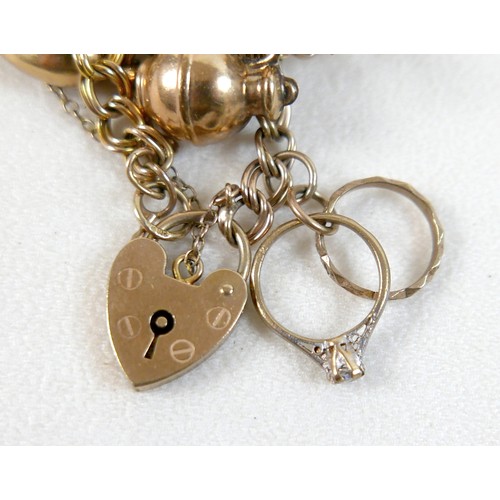 174 - A 9ct yellow gold charm bracelet with eight charms, 25.7g.